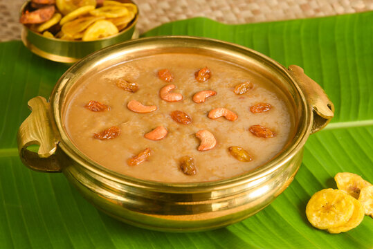 Parippu Payasam Pradhaman  or Moong Dal Kheer Indian sweet Kerala food for Onam festival special dessert Mithai for Onam sadya , sadhya in green banana leaf background. Also popular Sri Lankan food . 