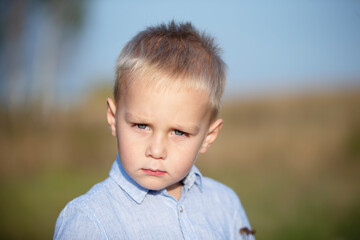 Portrait of a blond and blue-eyed three-year-old boy.