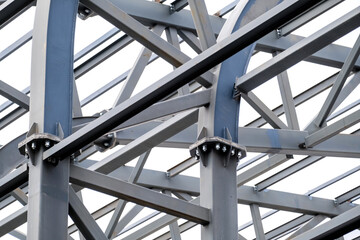 Fototapeta na wymiar Row of stadium roof metal supports structure. Industrial steel background.