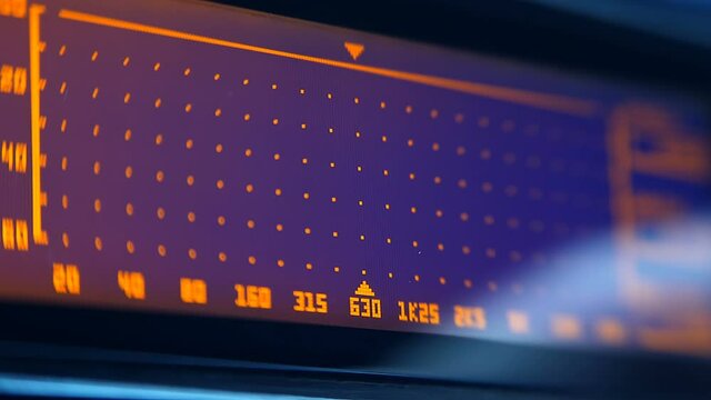 The hand turns the knobs of feedback suppressor allows the use of a strong reduction the signal level of the specified frequency ranges, to remove certain frequencies leading to feedback. Closeup