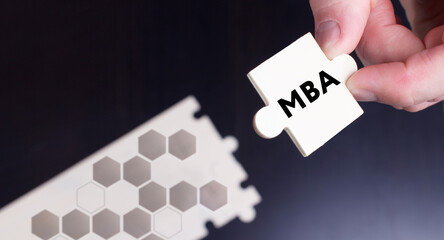 Business, Technology, Internet and network concept. Young businessman shows the word: MBA