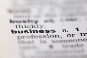 Macro close up of old English dictionary page with word business
