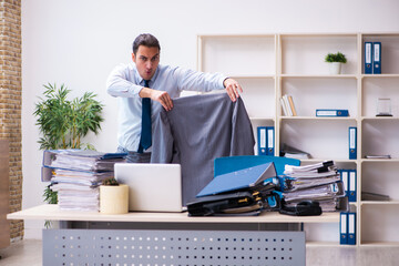 Young male employee unhappy with excessive work