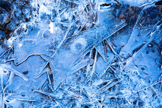 Patterns in ice of a frozen stream in the Swiss Alps