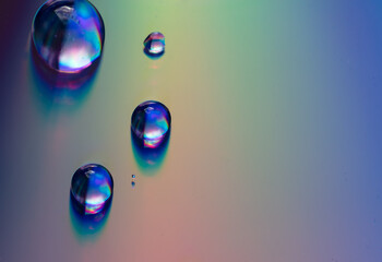 Water drops on a rainbow background.