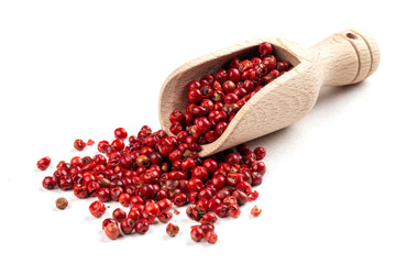 Isolated wooden scoop of red peppercorns