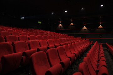 Empty cinema hall with red seats. Movie theatre