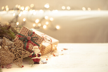 Christmas background with decorative santa figurine on blurred background.