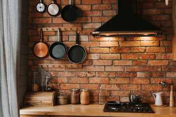details of a cozy kitchen interior with a brick wall
