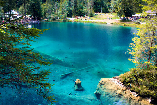Lake blausee with the mermaid in the foreground, highlighted for being a fairytale lake with crystal clear blue waters and transparent turquoise