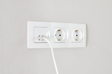 electrical and ethernet white socket on the wall.