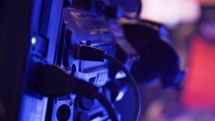 Sound and TV engineer working on a mixing panel in a dark room setting for a game event production in Krefeld, Germany.