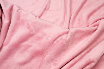 The blanket of furry fleece fabric. A background soft plush fleece material with a lot of relief folds