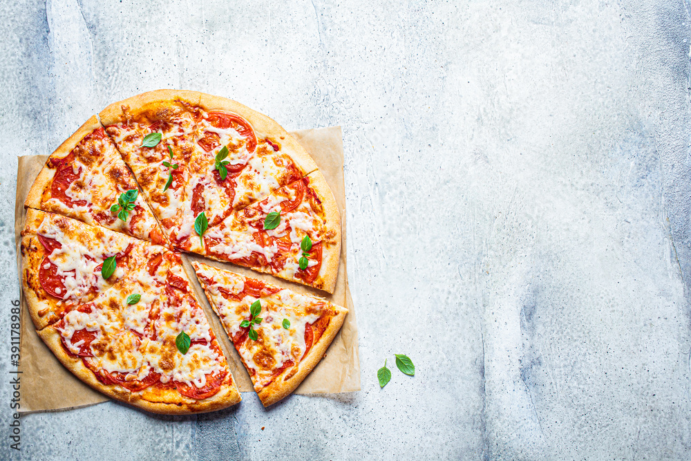 Canvas Prints Classic pizza Margherita with mozzarella, tomato and basil, gray background, top view, copy space. Italian food concept.