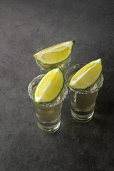 three shots of tequila with lime and salt.
