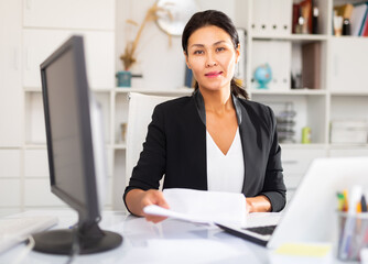 Business woman hands over document for signing in the office