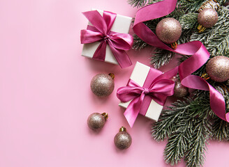 Christmas gifts, pink decorations on pastel pink background.