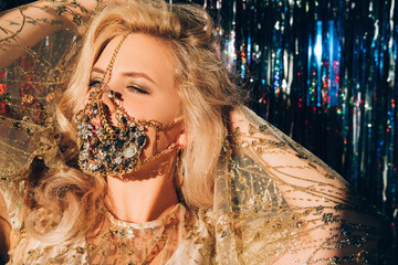Pandemic fashion. Christmas party. Festive look. Sensual blonde woman in glamour gold jewelry chain...