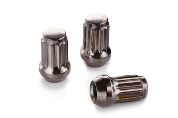 three grey shiny nuts for alloy wheels and auto tuning on a white isolate background