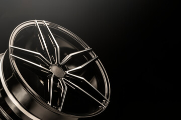 New black shiny alloy wheels rim. light from above, copyspace
