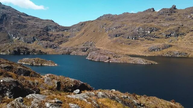 4K daytime video looking over the beautiful 4th lagoon (lake) of Pichgacocha in the Ambo region, Huanuco, Peru at more than 4000 meters altitude. Wide angle shot. Truck left to right. 30 fps