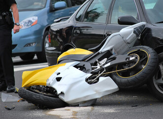 Car and motorcycle accident outdoors.