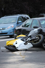 Car and motorcycle accident outdoors.