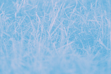 Blue blurred abstract background with pale pink grass pattern