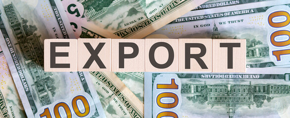 Concept words EXPORT on wooden blocks on a beautiful background from dollar bills.