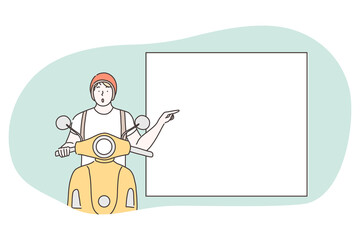 Demonstration, promotion, paying attention, advertisement concept. Young surprised frustrated motorcyclist riding and pointing with forefinger at white blank placard with copy space for text 