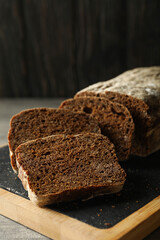 Board with fresh rye bread, close up