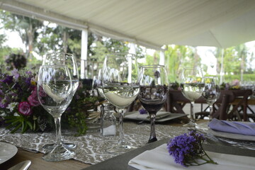 Table prepared for a wedding with purple flowers