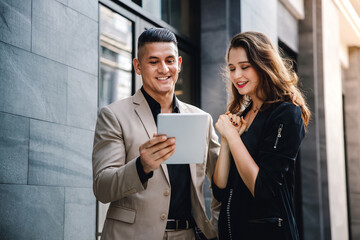 Teamwork or Two Partnership Work Together Concept. Businessman and Business Woman Working on Tablet outside the Office