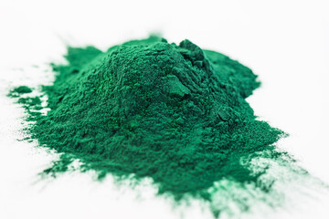 Spirulina powder on a white background.