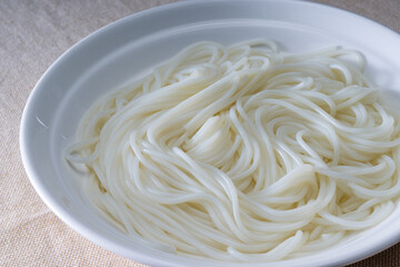 Close-up of a bowl of white and smooth rice noodles