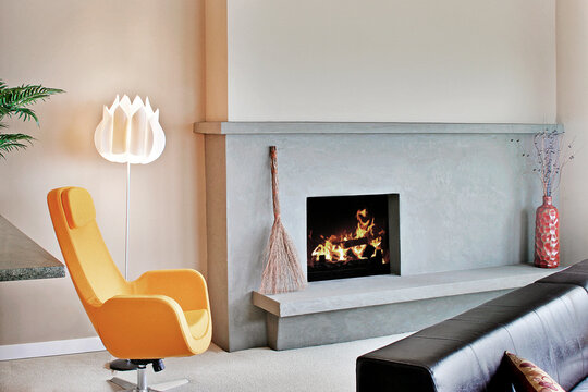 Living room in a modern house, chairs and fireplace