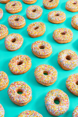 Iced donuts on blue paper