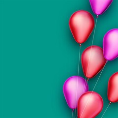 Red and pink foil balloons with threads on green background.