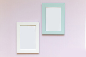 Mock up portrait white frame and blue frame on pink paper background. Scandinavian style.