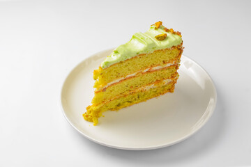 Pistachio Classic cake isolated on white. A piece of pistachio cakeserved on a white plate over white background.
