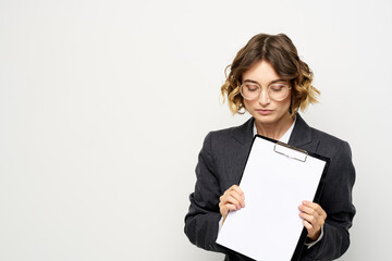 Business woman with a folder of documents on a light background cropped view and shirt suit