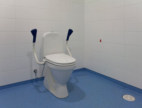 Accessible Toilet, a spacious cubicle with toilet bowl and adjustable side rails