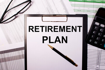 RETIREMENT PLAN is written on a white sheet of paper, near the glasses and the calculator.