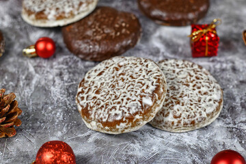 German round gingerbread called 'Lebkuchen' with white and chocolate glazing surrounded by seasonal Christmas decoration