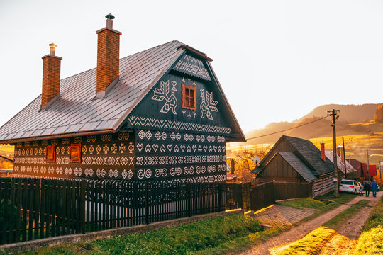 Old wooden houses in Slovakia village Cicmany in autumn. Unique decoration of log houses based on patterns used in traditional embroidery in village of Cicmany, UNESCO World Heritage Site, Slovakia