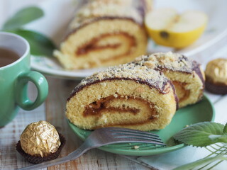 Closeup of pastry roll stuffed with apple jam on a wooden background. Home cooking.