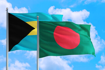 Bangladesh and Bahamas national flag waving in the windy deep blue sky. Diplomacy and international relations concept.