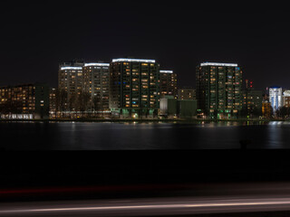 Fototapeta premium A modern residential district casting reflections to the waterfront.