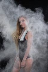 Portrait of a girl in a black bodysuit with flour