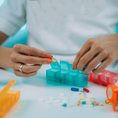 Medicine non adherence. Woman holding pills in her hand, not sure if she had taken the medicine or not